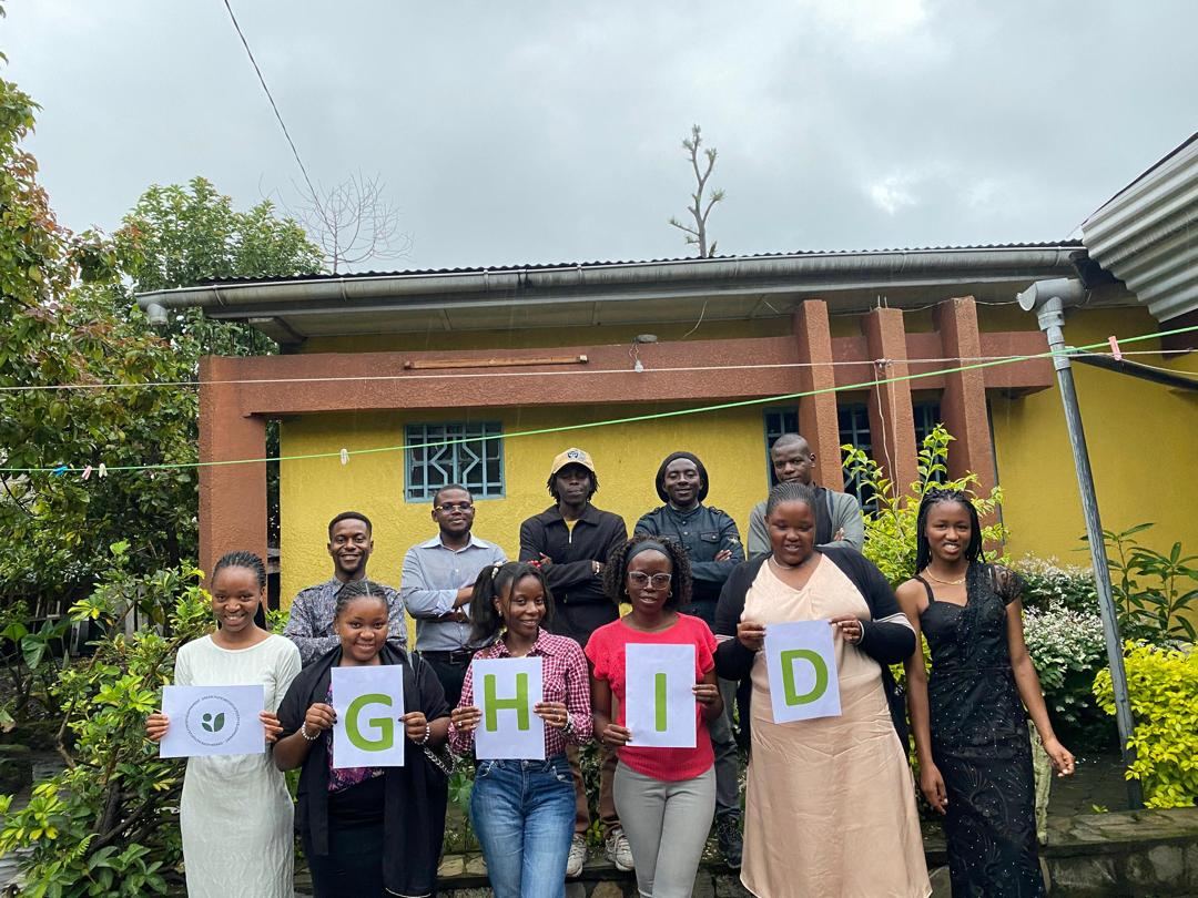 GHID members holding the letters G, H, I, D in front of the office in Goma